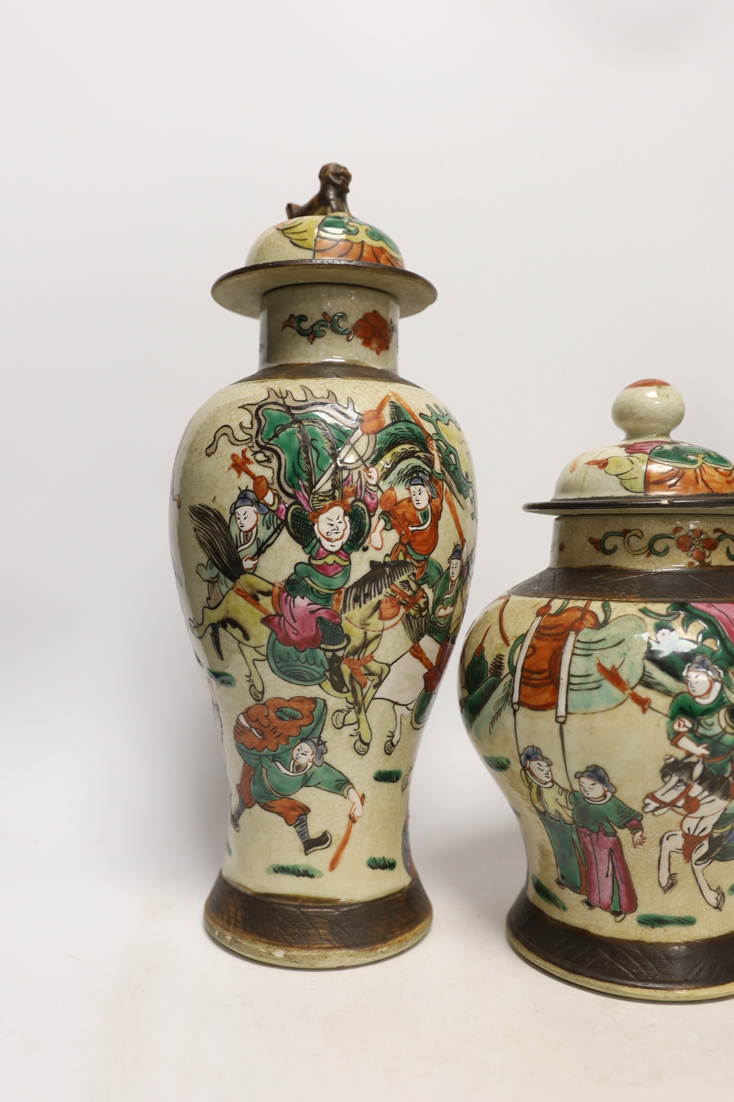 Three various Chinese crackleware famille rose jars and covers including a baluster example, largest 35cm high